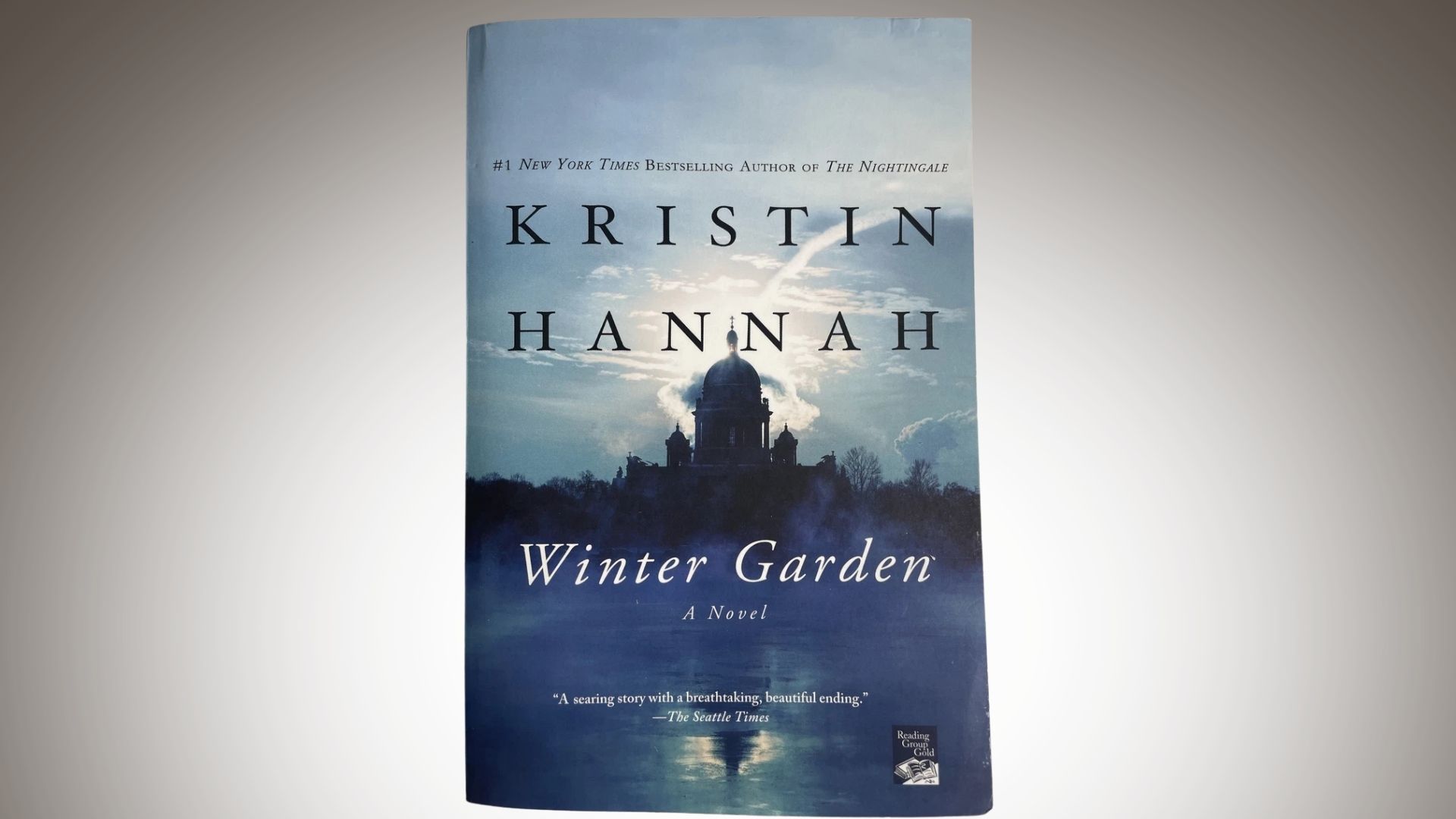 Book cover of "Winter Garden" by Kristin Hannah, featuring a snowy landscape and a silhouette of a woman in a winter coat.