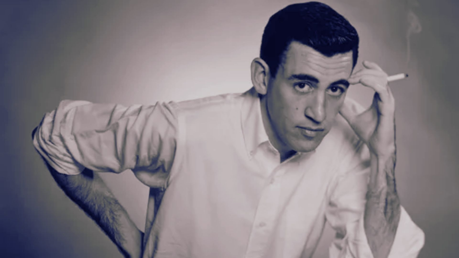 1. A man in a white shirt holds his hand to his head, appearing contemplative or stressed.