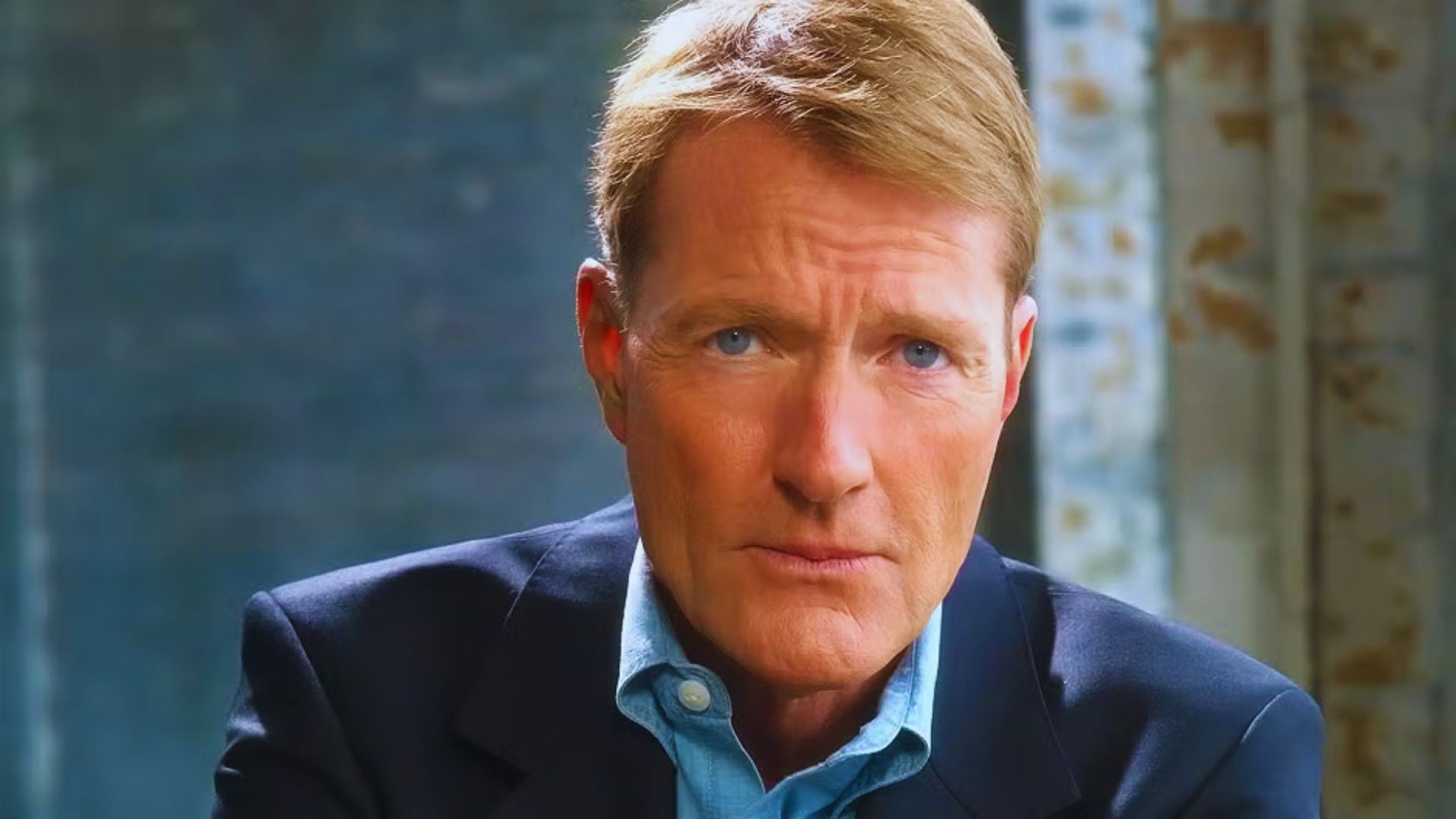 Lee Child, the author, is seen in a suit and blue shirt, exuding a polished and professional appearance.
