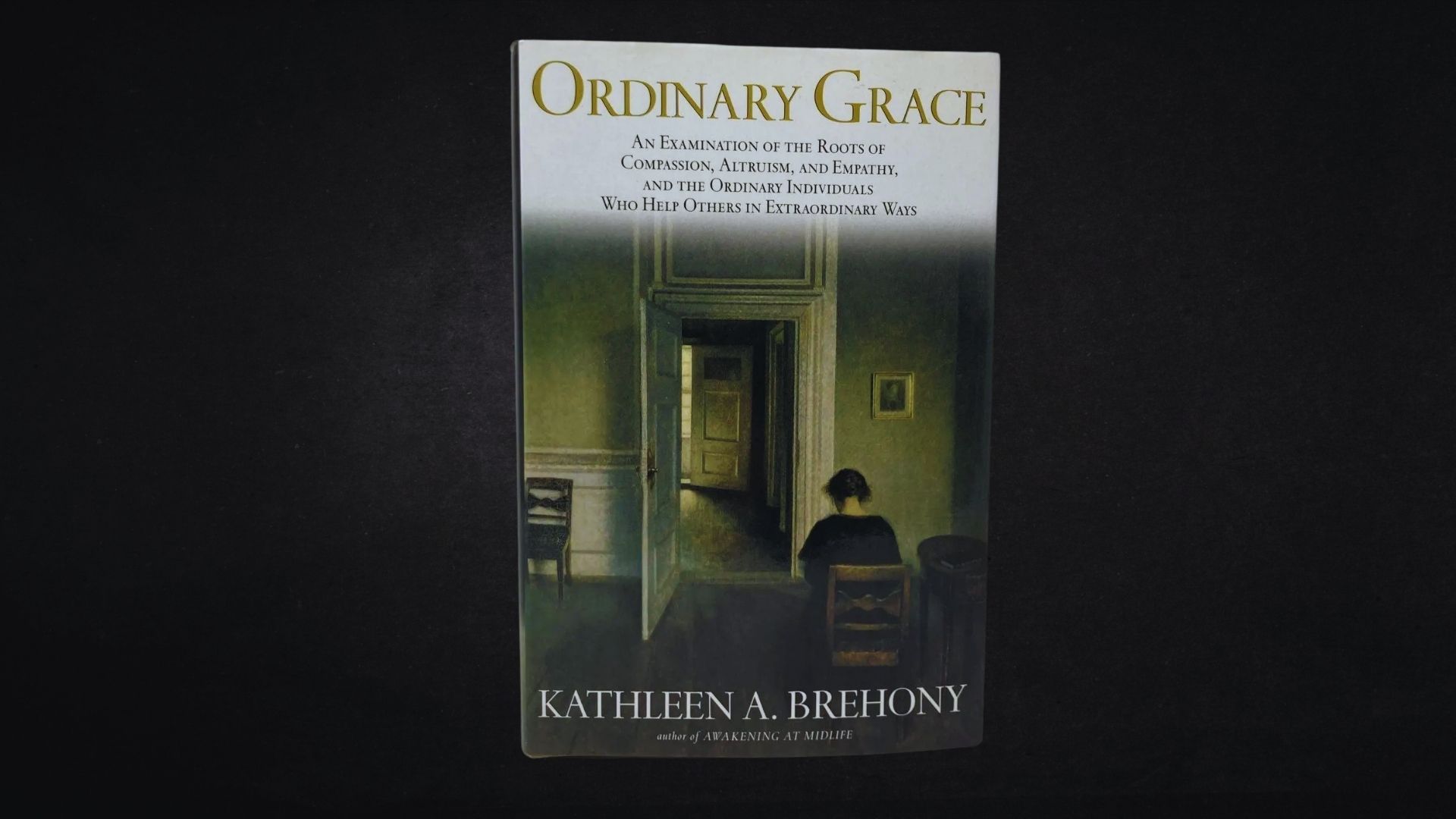 Book cover of "Ordinary Grace" featuring a serene landscape with a winding road and trees under a cloudy sky.