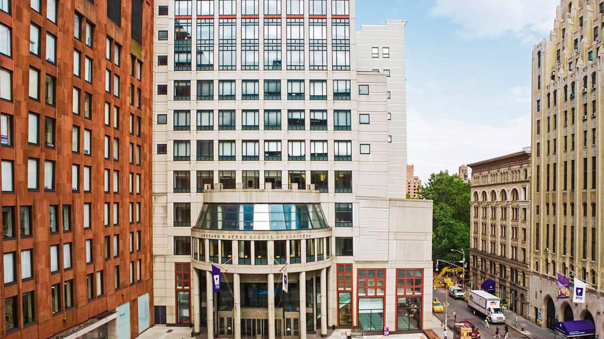 A large building with numerous windows and a prominent clock, representing NYU Stern School of Business.