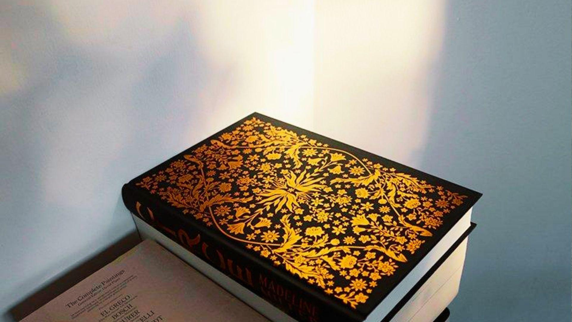 A book featuring intricate gold and black designs on its cover, showcasing an elegant and artistic appearance.