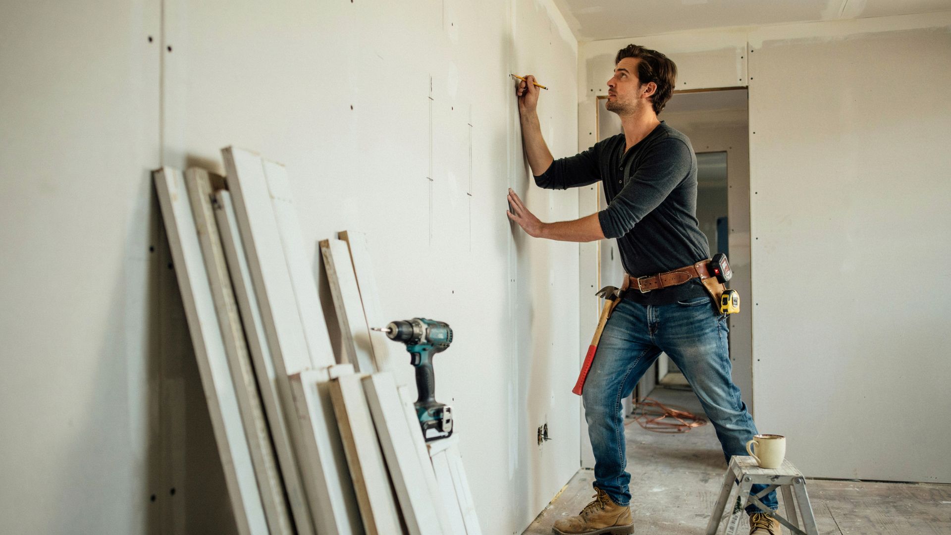 Marking wall studs before installing shiplap.