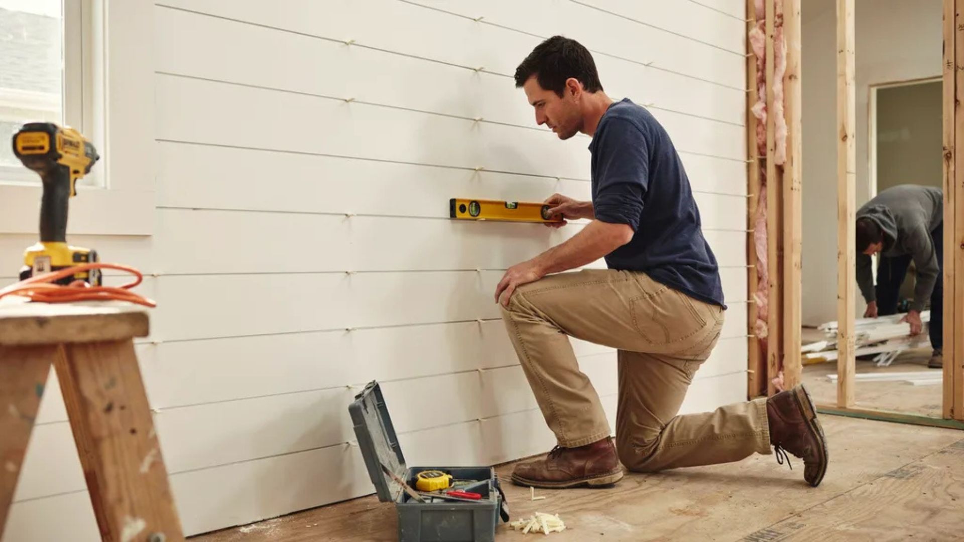 Adding additional shiplap boards to complete the wall.