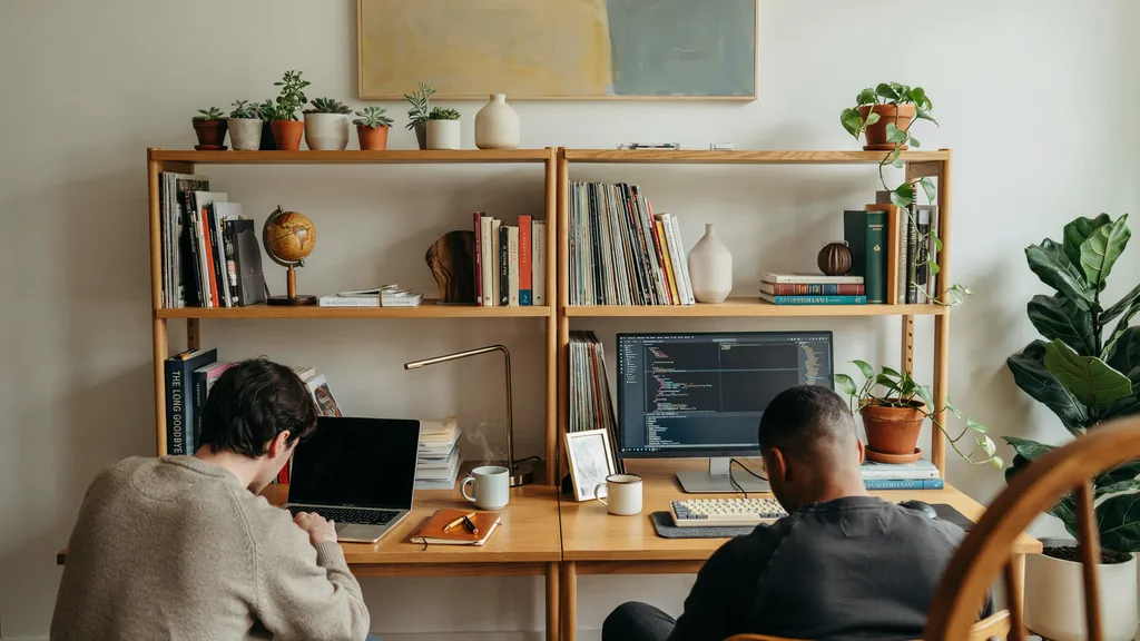 Two bookshelves used as dual-person desk setup.