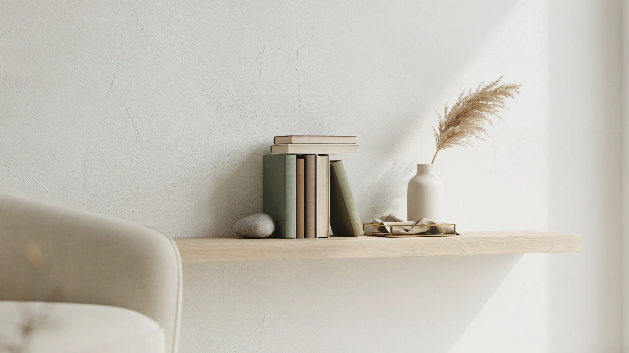 Minimalist bookshelf with intentional empty space between decor items.