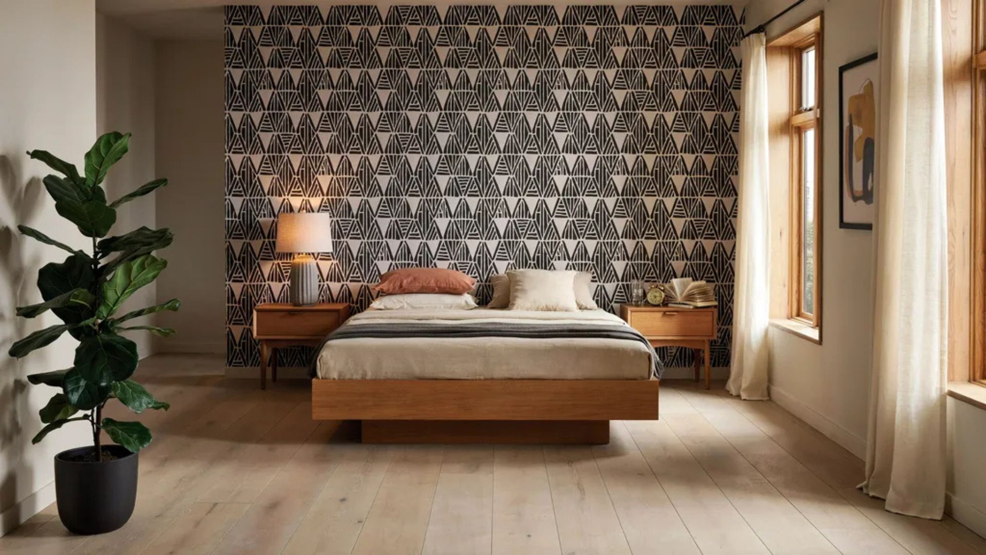Bedroom featuring a geometric wallpaper accent wall.