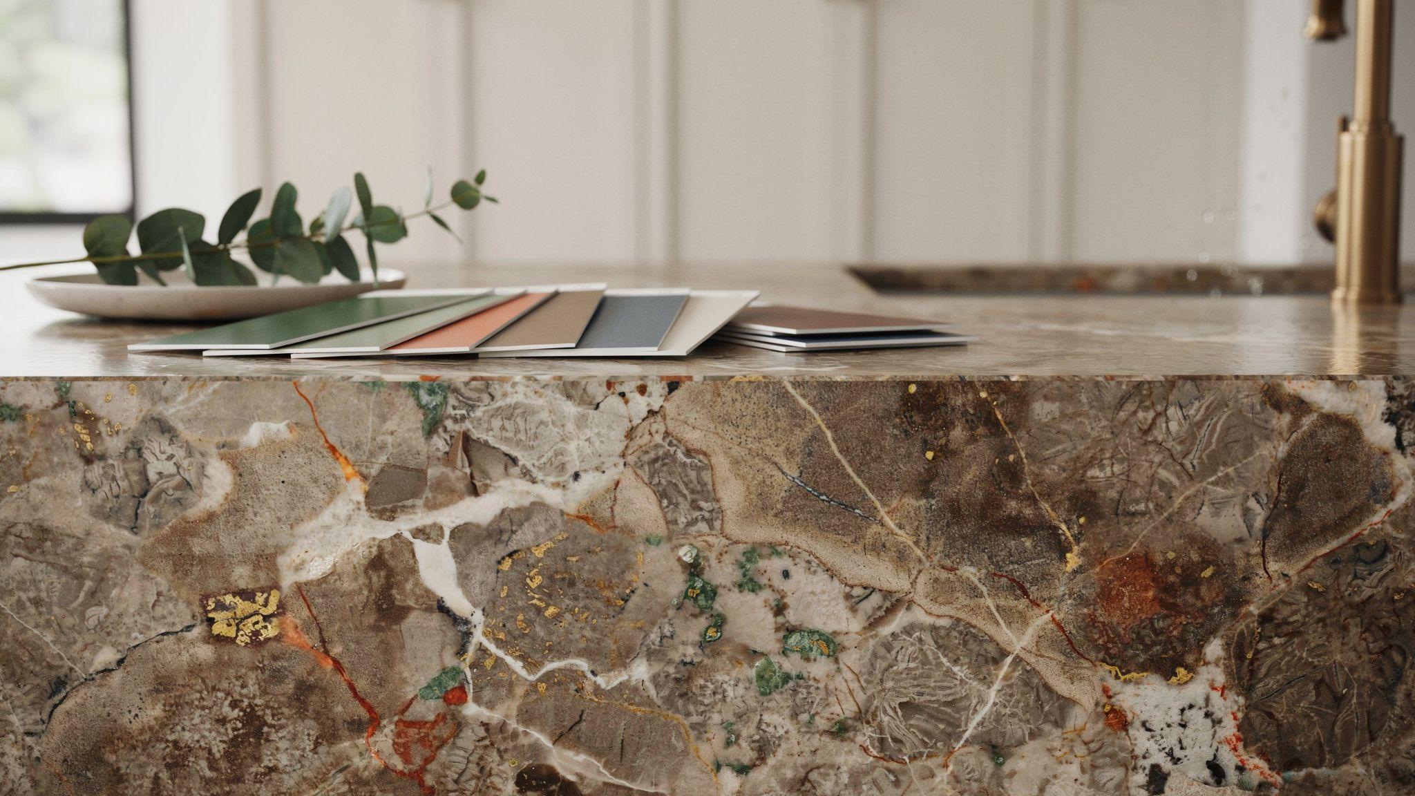 Brown granite countertop displaying natural undertones beside coordinating kitchen cabinet color samples