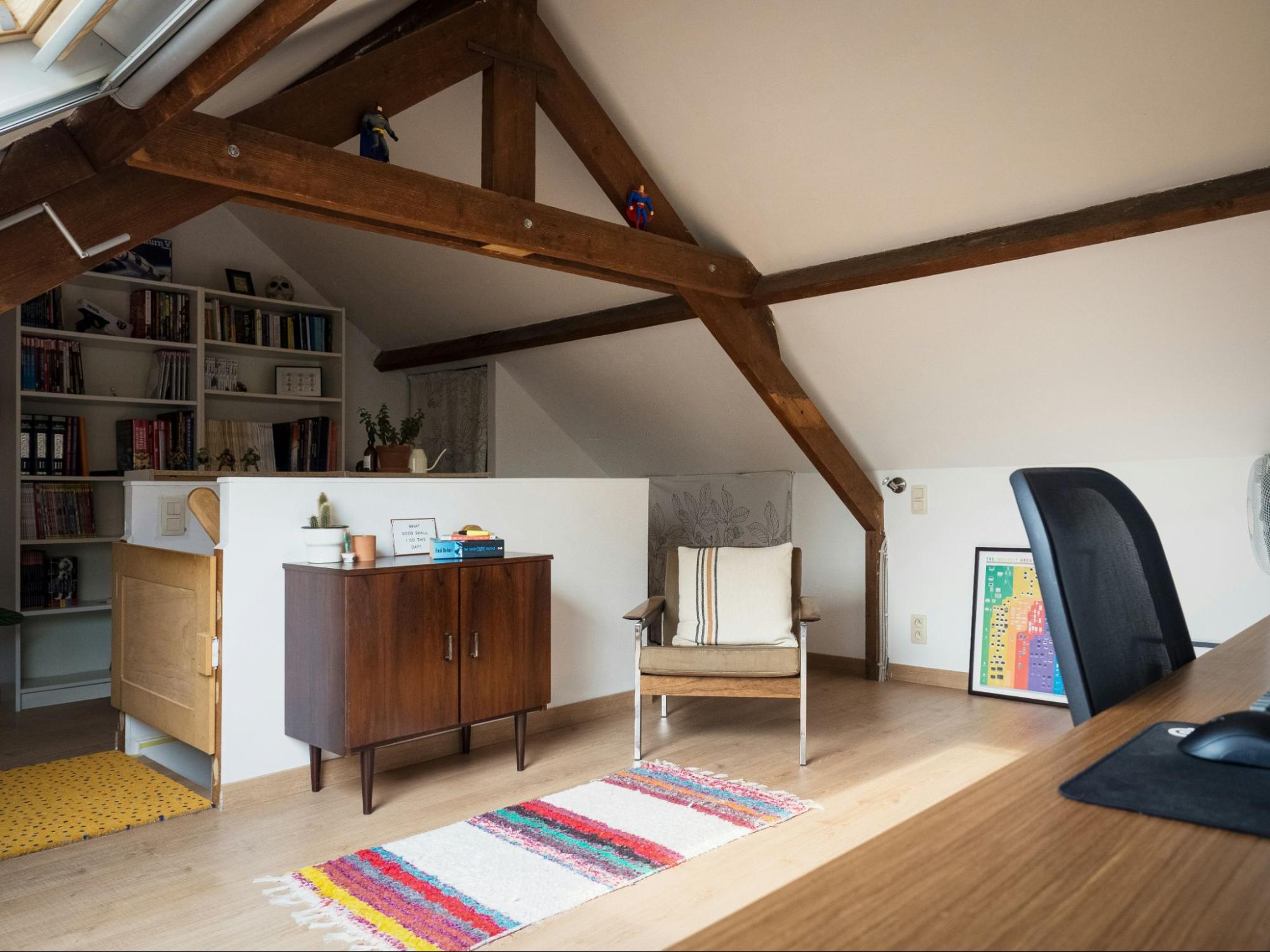 A modern loft featuring a desk and chair, showcasing a minimalist workspace design.